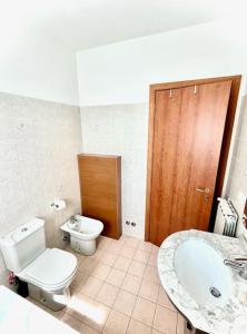 a bathroom with a toilet and a sink at Dimora del Viaggiatore in Marina di Carrara