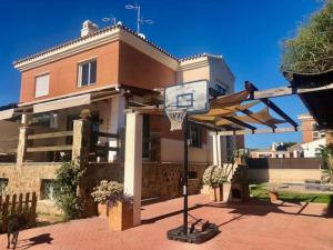 a basketball hoop in front of a house at Townhouse, private pool garden and sea views in Torremolinos