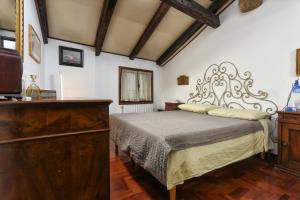 um quarto com uma cama e uma cómoda em madeira em Cà del paradiso em Veneza