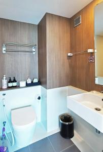 a bathroom with a toilet and a sink at Blossom Sathorn Hospitality （曼谷高端酒店公寓） in Bangkok