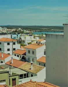 a view of roofs of buildings in a city at urban beach sixties in Portimão