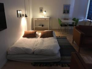 a bedroom with a bed with two pillows on it at Astas Apartment in Aalborg