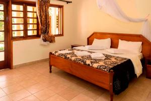 Postel nebo postele na pokoji v ubytování Kalya Courts Hotel Fort Portal