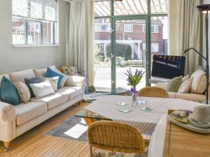 a living room with a couch and a table at Reedham Retreat in Reedham