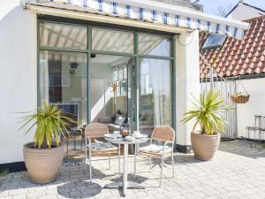 a patio with chairs and a table with plants at Reedham Retreat in Reedham