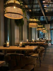 a row of tables and chairs in a room with lights at Grand Laola Spa in Pobierowo