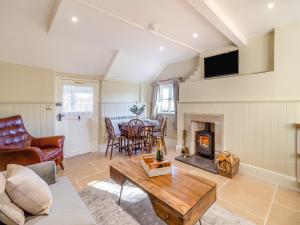 a living room with a fireplace and a table at The Lodge in Wonastow