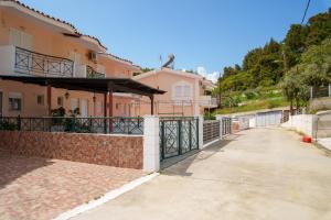 a house with a gate and a driveway at Golden Horizon Haven in Preveza