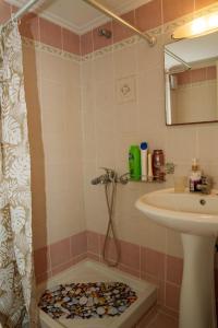 a bathroom with a shower and a sink at Golden Horizon Haven in Preveza