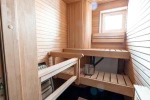 a sauna with wooden shelves and a window at 2ndhomes Stylish 1BR home with Balcony and Sauna in Kamppi Center in Helsinki
