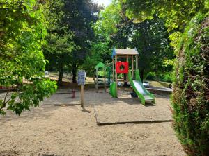 a playground with a slide in a park at Grand appartement calme à 30 min de Paris in Morsang-sur-Orge