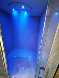 a shower with blue lights in a room at Le Churchill Hôtel & Spa in Carnac