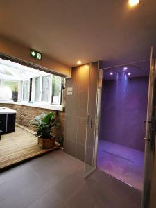 a shower stall in a bathroom with a deck at Le Churchill Hôtel & Spa in Carnac