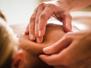 a woman getting her face massage with her hands at Le Churchill Hôtel & Spa in Carnac