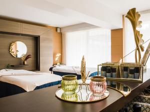 a hotel room with two beds and a table at Le Churchill Hôtel & Spa in Carnac