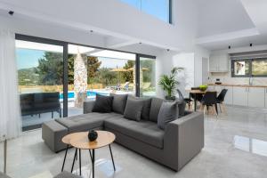 a living room with a couch and a table at Aiora Luxury Villas in Afantou