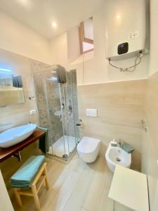 a bathroom with a shower and a toilet and a sink at Le Casette Gargallo 1 - Ortigia in Syracuse