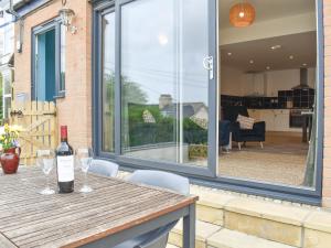 a table with a bottle of wine and two glasses at High Tide in Combe Martin