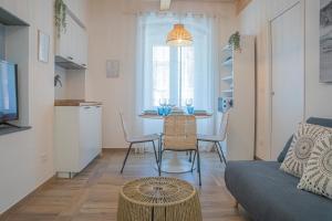 a living room with a table and a couch at Moneglia in Piazza in Moneglia