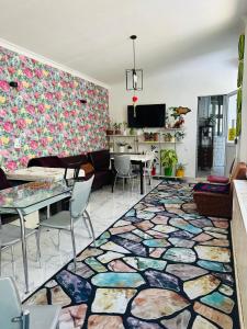a living room with a colorful rug on the floor at Sweet Home Hostel in Bishkek