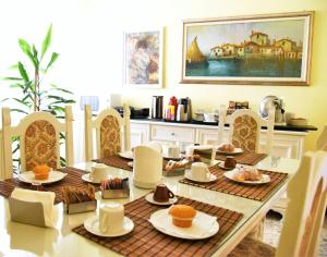 a dining room table with plates of food on it at B&B Stella in Salerno