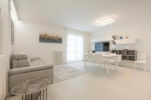 a white living room with a couch and a table at Residence Luxury Elisabeth in Caorle