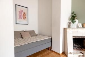 a bed in a room next to a fireplace at 2ndhomes 1BR Apartment in the Center of Helsinki in Helsinki