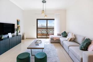 - un salon avec un canapé et une télévision dans l'établissement FAM Living - Beach Escapes in Palm Jumeirah, à Dubaï