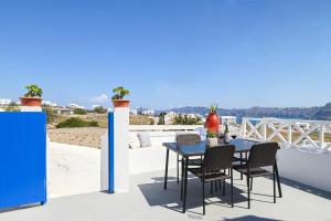 a table and chairs on a balcony with a view at Mary Castelia Villa with Jacuzzi in Akrotiri