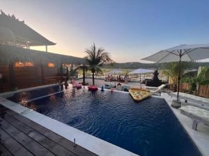 a swimming pool with a pizza in the water at Mista Ceningan's Beach Bungalows in Nusa Lembongan