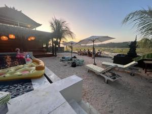 a beach with a large inflatable raft and a pool at The KUBU 221 in Nusa Lembongan