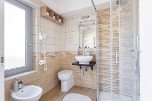 a bathroom with a toilet and a sink and a shower at ORISTANO 5 Pers APPARTAMENTO in Oristano