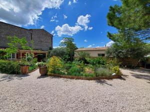 a garden in front of a house at La Dolce Vita - Chambre Cristoforo Colombo in Montpeyroux