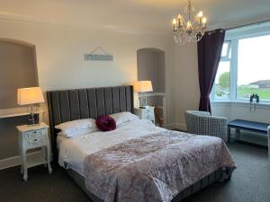 a bedroom with a large bed with a large window at "Room only" at Wetherby Nairn in Nairn