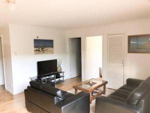 un soggiorno con un divano e una TV di Coastal Hideaway - Venus Bay (1st Estate) a Venus Bay