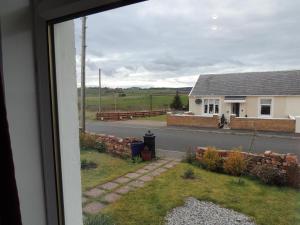a view from a window of a house and a street at Burns Cottage in Dalleagles