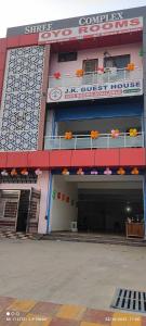 a large building with a parking lot in front of it at OYO Gupta Guest House in Morādābād