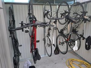 two bikes are hanging up in a garage at "Ter Ename n°2" in Oudenaarde