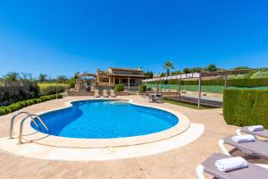 a swimming pool in a yard with a house at Ideal Property Mallorca - Sa Sinia in Lloret de Vistalegre