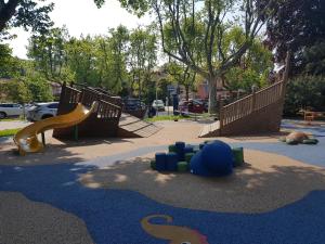 a playground with two slides and a slide at Appartamento Piccolo Porto di Cerro in Laveno-Mombello
