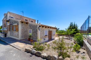 a stone house with a garden in front of it at Ideal Property Mallorca - Sa Sinia in Lloret de Vistalegre