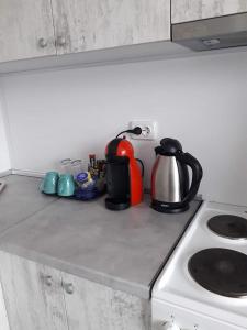 a kitchen counter with a tea kettle and a stove at Апартамент Ели in Veliko Tŭrnovo