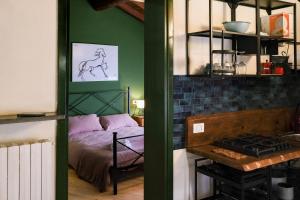 a room with a bedroom with a bed and a stove at Elio's secret spot in Crema