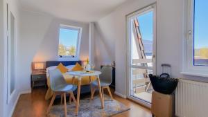 ミエンジズドロイェにあるVilla Elefantの小さなアパートメントで、テーブル、椅子、窓が備わります。