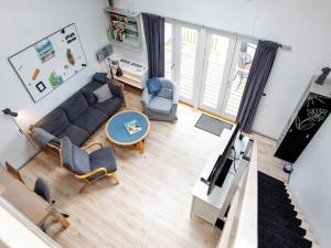 an overhead view of a living room with a couch and chairs at 6 person holiday home in Vestervig in Vestervig