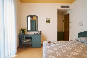 Postel nebo postele na pokoji v ubytování Aparthotel La Pineta
