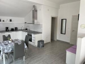 a kitchen and dining room with a table and chairs at Studio Apartman Rubinić in Lovran