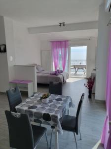 a living room with a table and chairs and a bed at Studio Apartman Rubinić in Lovran +14 photos
