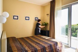 Postel nebo postele na pokoji v ubytování Aparthotel La Pineta