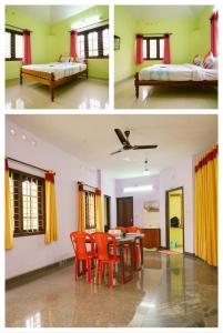 Habitación con 2 camas, mesa y sillas en MUNNAR FALCUNS INN HOMESTAY en Munnar